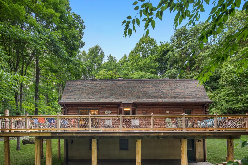 The existing deck columns were unattractive and spindly 4x4 posts, which we clad with cedar logs that had been quartered and were reassembled around the posts.